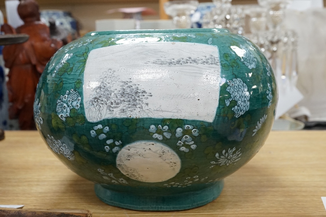 A Chinese enamelled porcelain oval bowl, Guandong kilns, early 20th century, green with en grisaille panels, 20cm high